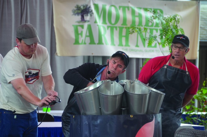 Joel Salatin, right, leads a demonstration on processing poultry at Mother Earth News Fair. 