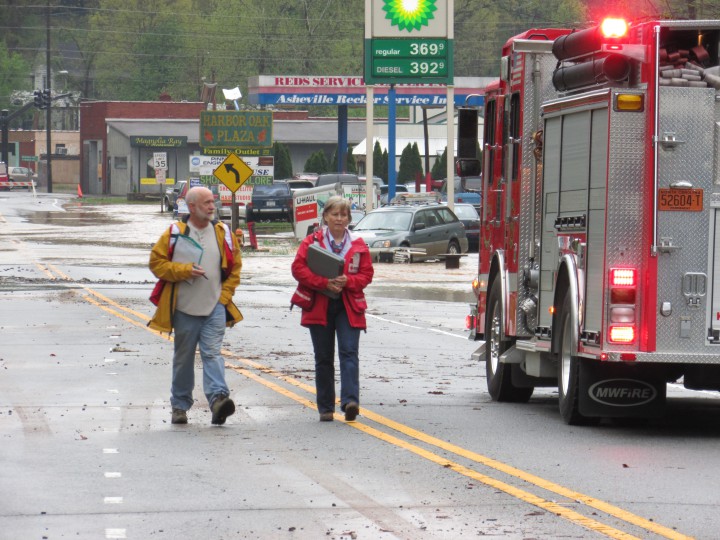 Red Cross Disaster Volunteers Pete Kirchner and Dee Besecker survey damage caused by early morning flash flood in Woodfin.  