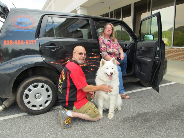 Terri Sizemore and Tom Durancik with Sizemore’s service dog, Mishka. Photo courtesy of Land of the Sky Regional Council