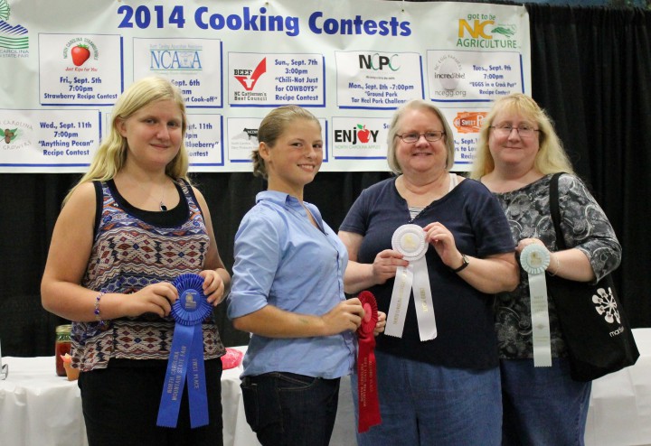 BERRY NICE: From left, Emma Gates, 12, took home first place and $100 in the recent N.C. Strawberry Association at the WNC Mountain State Fair for her strawberry-basil frozen yogurt dessert. Jenna Ross placed second and earned $50 for her sweet strawberry soup.  Connie Pegg won third place and earned $25 for her recipe for strawberry-jalapeño tomato jam and  honorable mention was given to Sharon Gates for her strawberry lemonade pie. All the winners are from Buncombe County. Photo by Hayley Benton