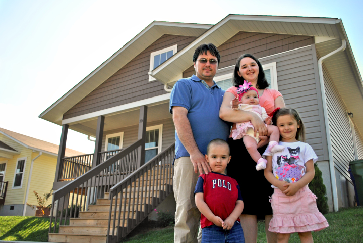 The Baran family in front of their Carney Place home. Photo courtesy of Asheville Area Habitat for Humanity