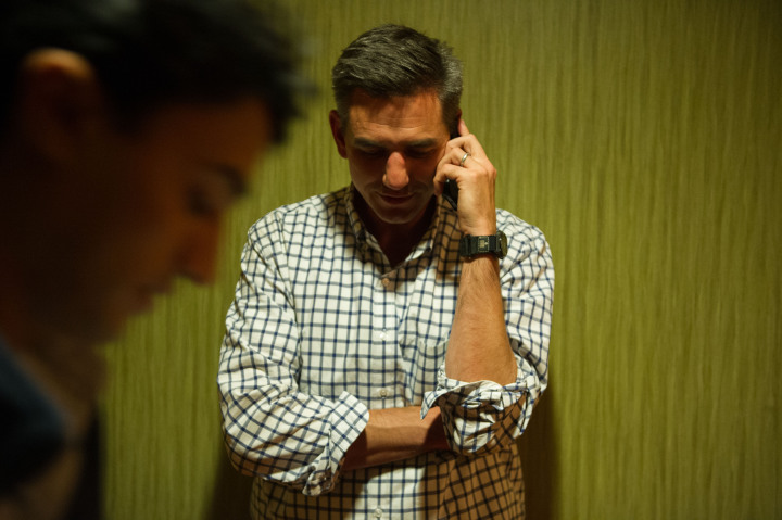 Brian Turner takes a concession call from Tim Moffitt on election night while his campaign manager, Sagar Sane, observes.