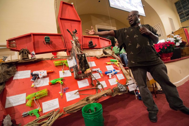 Activist Dwayne Barton presents a wall representing toy guns that police sometimes mistake for real guns, which ends in tragedy for black youths. "These toys that kids like to play with, they don't realize they are bad for them," he said. 