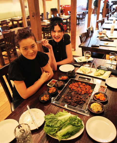 From left, Korean House owner and chef Kristina Im and server Maya Fitzdare at one of the restaurant's new grills. Photo by Jayson Im