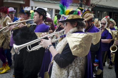 WELL PLAYED: Early iterations of the local Mradi Gras parade included performances by Firecracker Jazz band and Unifire performance troupe. Photo by Carrie Eidson