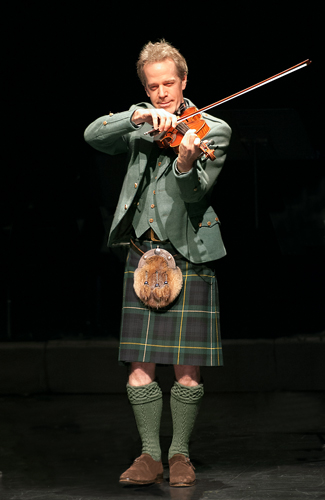 Jamie Laval fiddles traditional Scottish music on stage. Photo courtesy of Genesis Photography