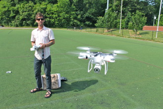If you fly them, you're going to crash them: Dan Caylor with his drone at Memorial Stadium in Asheville