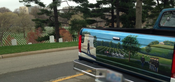 Tom Riddle's truck parked in Arlington National Cemetery, beside the perfectly symmetrical tombstones Andrea Martin repainted six times on Riddle's tailgate.  (PHOTO BY ANDREA MARTIN)