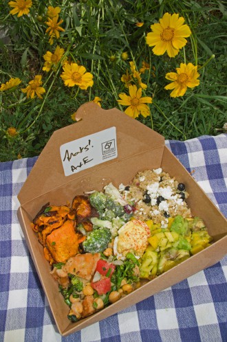 PICNIC IN A BOX: 67 Biltmore still carries many menu items that were popular at Laurey's, some of which can be included in ready-made personal picnic boxes. This one features sweet potato salad; broccoli salad; quinoa salad with blueberries and goat cheese; Easy Rider deviled eggs; mango-avocado salad and Syrian salad with chickpeas, mint and grilled pita.  The deviled eggs are named after a longtime customer who passed away. He loved Laurey's deviled eggs and rode his motorcycle to the café to eat them four times a week. Photo by Cindy Kunst 