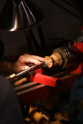 Jim McPhail turning tiny wooden bowls on his lathe. Photo courtesy of SHCG 