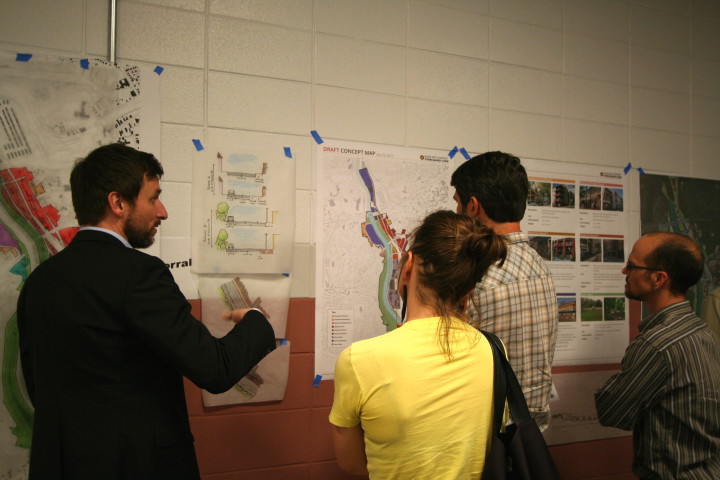 FACILITATING FEEDBACK: Project consultant Joel Mann discuses one of several maps generated from the charrettes with local residents. Meeting attendees were invited to leave comments of the charrette series in an exit survey at the conclusion of Wednesday's presentation. Photo by Max Hunt.