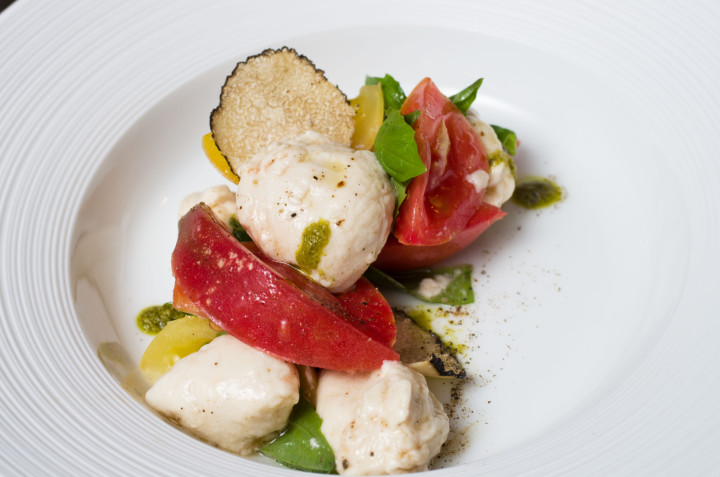 CHEESE, PLEASE: Plant's tomato plate features chef Jason Seller's fresh almond-based mozzarella with heirloom tomatoes, basil and black truffle.    Photo by Cindy Kunst