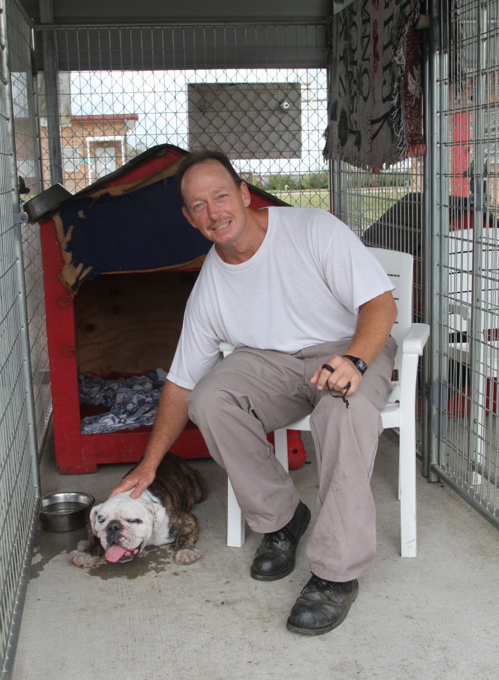 Inmate and trainer, Kenneth Handy, with Sherman, a eight year old English Bulldog that suffered abuse by breeders.  According to fellow inmate and trainer, Chris Tarantino, Sherman was part of a puppy mill and "breed to death."  Photo by Sarah Adeline Harnden