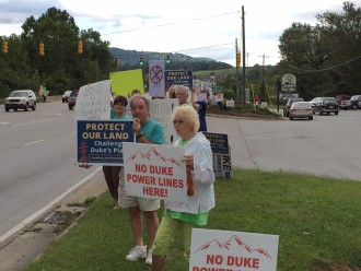SPEAKING OUT: Protesters lined the street in front of the Mills River Valley Ag Farm & Garden store to protest Duke's proposed routes through the Mills River community. Photo courtesy of Kathy Ziprik.