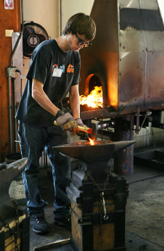 A student discovers the ancient craft of blacksmithing at the Folk School. The Folk School’s state-of-the-art blacksmith shop hosts more blacksmithing classes per year than any other school in the country, drawing students from allover the United States. Photo submitted