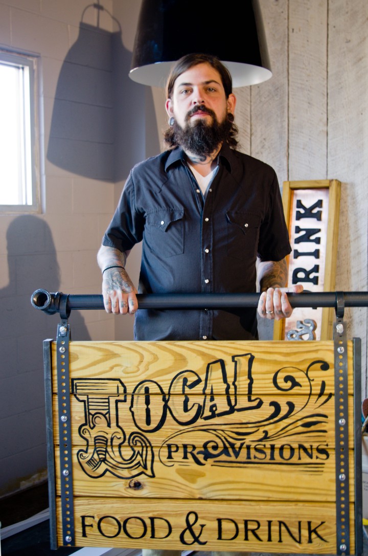 A GOOD SIGN: Chef Justin Burdett commissioned Hendersonville tattoo artist Mike Pace — the man responsible for much of Burdett's ink — to create signage for Local Provisions. Photo by Cindy Kunst