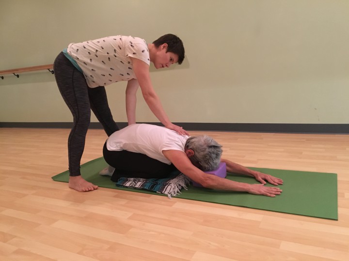 NO SURGERY NEEDED: Hilary Drake, left, helps Doris Rettig heal her back with yoga therapy at Asheville Family Fitness. Photo by Kate Lundquist
