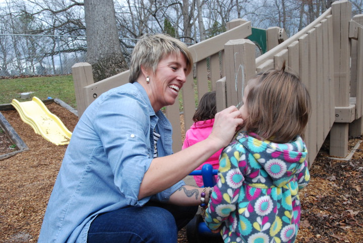 Laura Martin talks to Lilyana Ramirez on the playground at Verner Center for Early Learning. Martin is mental health and disabilities specialist at the Verner Center for Early Learning, which is an Early Head Start facility. Photo by Leslie Boyd