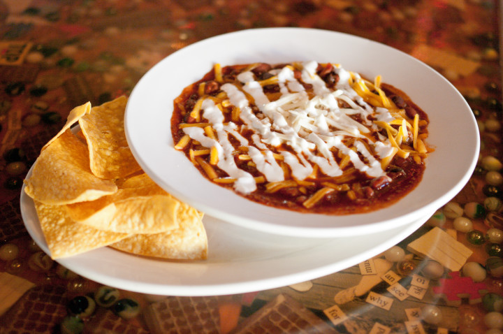 SPICE OF LIFE: Asheville restaurants offer varieties of chili to please every palate. Lucky Otter’s vegetarian chili is packed with beans and spices and topped with cheese and sour cream. Photo by Cindy Kunst