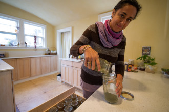 Janell Kapoor, Ashevillage  Founding Director mixes some homegrown herbal tea at Ashevillage Jan. 12. Photo by Pat Barcas.