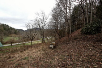 SITING THE SHOOTINGS: Looking down over the Shelton Laurel Valley. The site of the murders is commonly believed to have been somewhere at the edge of the field below. Photo by Max Hunt
