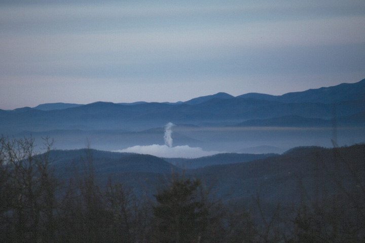INVERSION LAYER: This smokestack plume and the surrounding inversion layer of clouds (taken of the Lake Julian power plant when it was still owned by CP&L) demonstrate what happens when carbon-based emissions are released in a valley, says Grant Goodge, formerly of NOAA’s National Climatic Data Center in Asheville. Photo courtesy of Goodge