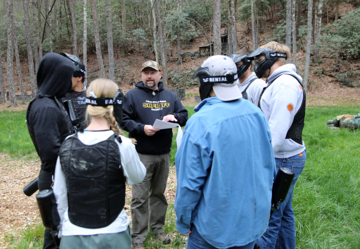 Transylvania County Sheriff David Mahoney instructs Brevard College students Monday in a simulation of a terrorist scenario. The students traveled to a local camp with rented paintball equipment as part of their criminal justice class. Photo by Joshua Cole