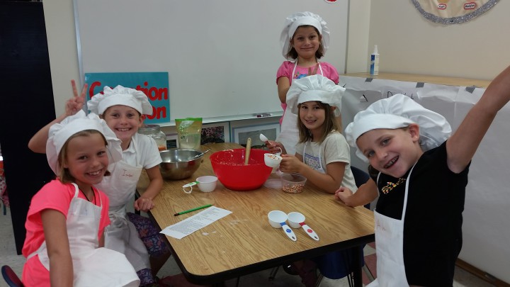 STARTING EARLY: These young bakers collaborate on a recipe at a camp hosted last year by World Peas. 