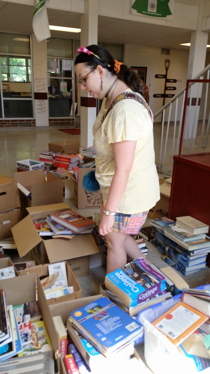 Mikaela Turner, class of 2012, browses through books in the lobby of Asheville Middle School.