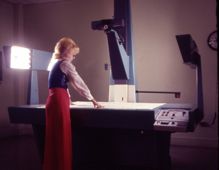 WHERE IT’S AT: A staff member works with filming maps in the ‘70s. Twenty-five petabytes, or 25 million gigabytes, of climate data has been stored on various forms of technology over the years. “I think we’re going to see, in the next five to 10 years, a leap in the evolution of how this information is used, and people will come here because this is where it’s at,” says Mike Tanner, executive director of NCEI’s Center for Weather and Climate. 
