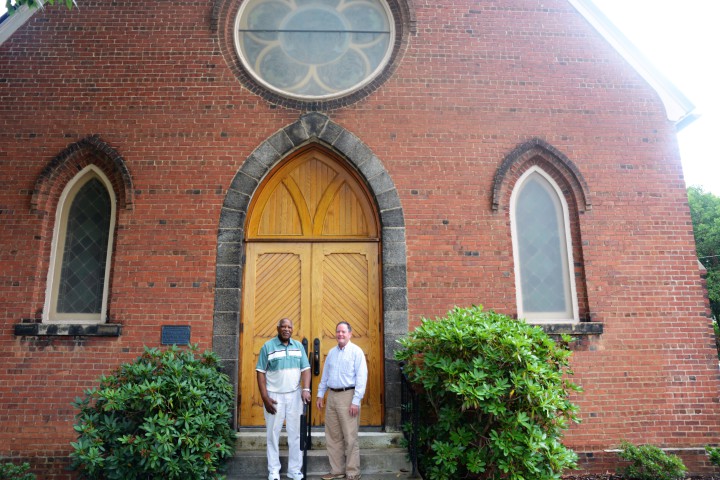 David Jones Jr. and Rev. Jerry Prickett stand in front of St, Matthias Church.