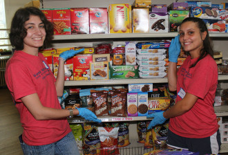 Tayla Clark '18, left, and Emma Noel '18 clean and restock shelves at Loving Food Resources during Service Day. Warren Wilson College is No. 13 on The Princeton Review's list of schools “most engaged in community service.” Photo by Jason Faulds/Warren Wilson College