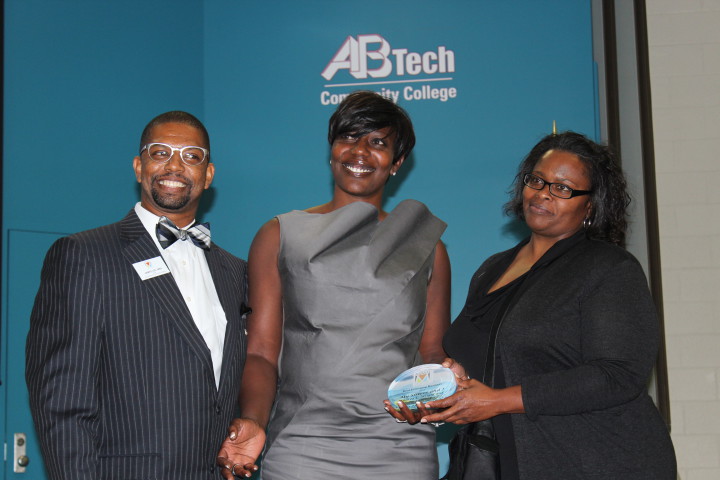 NEW BIZ OF THE YEAR: Andrea Wright, center, and Benita Chambers, right, accept the New Business of the Year award during Minority Enterprise Development Week on Sept. 29 from James Lee, chair of MED WEEK. Photo by Virginia Daffron