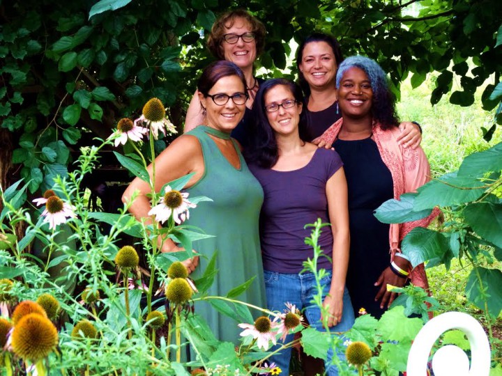 Wise Woman's Workplace: Southeast Wise Women year-round staff pose with echinacea. (L to R) Renee Conover, Programming & Production Corinna Wood, Director Carmen Lescher, Operations & Outreach Ema Carmona, Event Coordinator KIfu Faruq, Sister Love & Programming Team. Photo by Renee Conover.