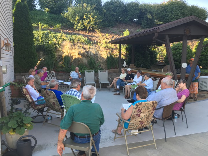CITIZENS TAKE ACTION: A high-density lakeside development proposal prompted community members in Weaverville to form the Lake Louise Preservation Association, whose members, pictured above, met at neighbors' homes. 