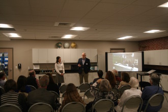 COMMUNITY-BUILT: AMOS officials like Anna Priest (left) joined TDA members such as John Ellis (right) to celebrate and reflect on the museum's journey from idea to reality during the grant presentation. Photo by Max Hunt