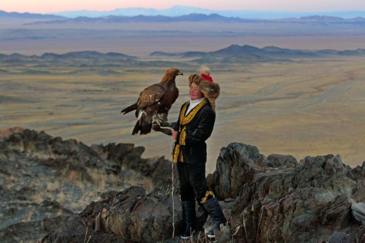 13 year old Ashol Pan with her eagle - Despite her young age, Ashol had the amazing ability to control and be able to caress her eagle, almost as if she had been with it for years. (Asher Svidensky/Caters News)