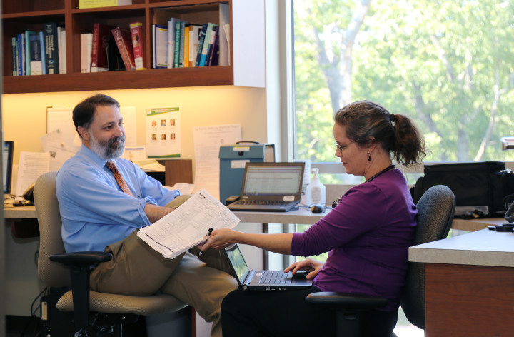 PREVENTION PIONEERS: Dr. Dan Frayne consults with Dr. Meredith Soles in the precepting room at the MAHEC Biltmore office. Photo by Kate Lundquist