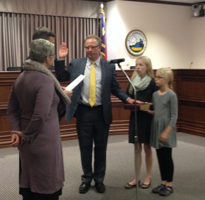 Newly elected Chair Brownie Newman takes his oath of office with his wife and kids alongside.