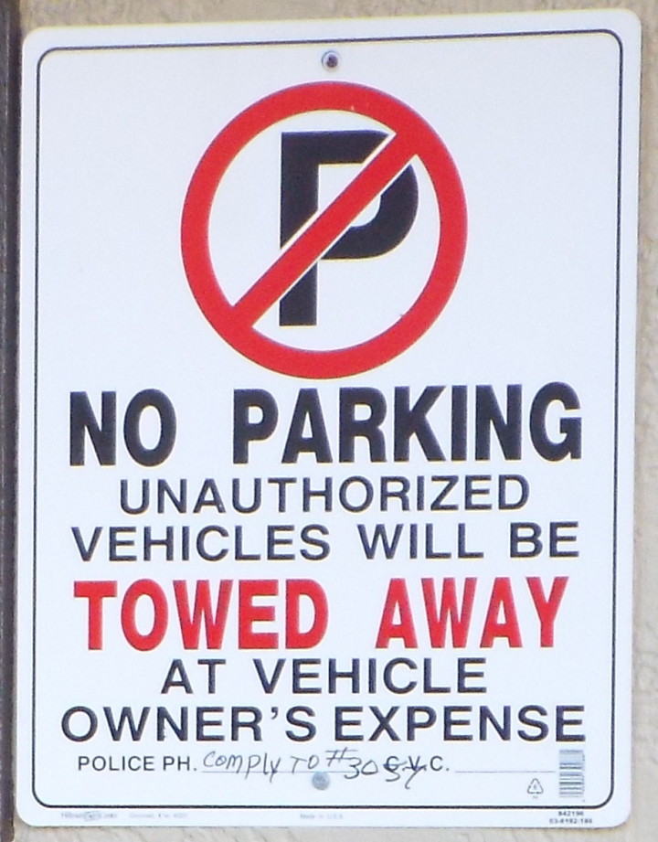 THE SIGN IN QUESTION: Harry Brown found the towing sign at 70 Market St. was not in compliance with the city's requirements of pre-notification for trespass towing because it was not within five feet of the street and did not meet the requirements for wording and sign size. Photo by Able Allen