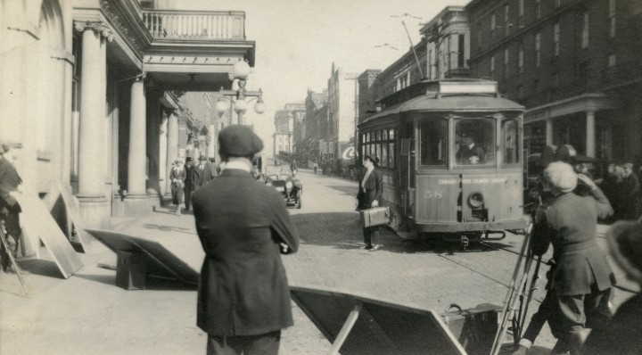 FROM ASHEVILLE TO ‘CANAAN’: Actor Thomas Meighan steps off a trolley car in front of the Swannanoa-Berkeley Hotel at 45-47 Biltmore Ave. Director R. William Neill stands with his back to us, while Harry Perry cranks the camera. Reflectors were used to coax a little more light onto the star. Photo courtesy of the N.C. Collection, Pack Memorial Library