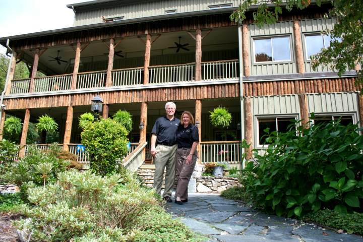 OPEN FOR BUSINESS:  Don and Kim Cason stand before The Esmeralda Inn & Restaurant in Chimney Rock. The couple owns and operate the inn. While the property was spared, the couple says their occupancy has been slow to pick back up. Photo courtesy of The Esmeralda Inn