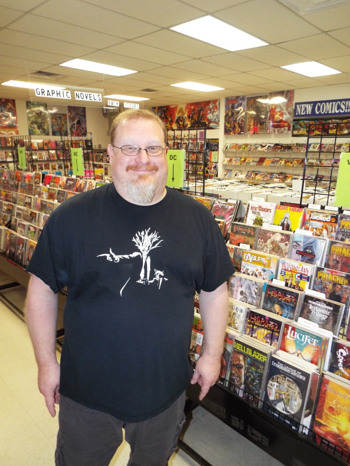 COMICS!: Scott Russell loves all kinds of comics and says he especially values the passionate community frequents his store. Photo by Able Allen