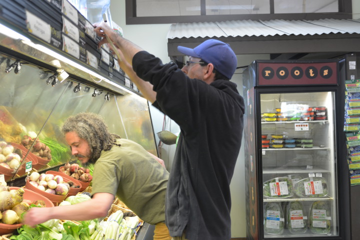 French Broad Food  Co-op produce manager, Jesse Reim (foreground) and general manager Bobby Sullivan in the produce section of the store.