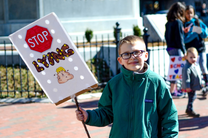 Gordon, 8, holding up his protest sign. 