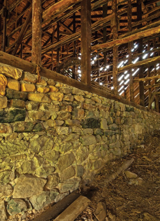 STRONG FOUNDATIONS: Madison County alone is home to over 10,000 barns, many of which were built wiht whatever materials were available to the homesteaders. The stone foundation above is believed to be the remnants of the original William Neilson Barn, built circa 1800. Photo by Taylor Barnhill