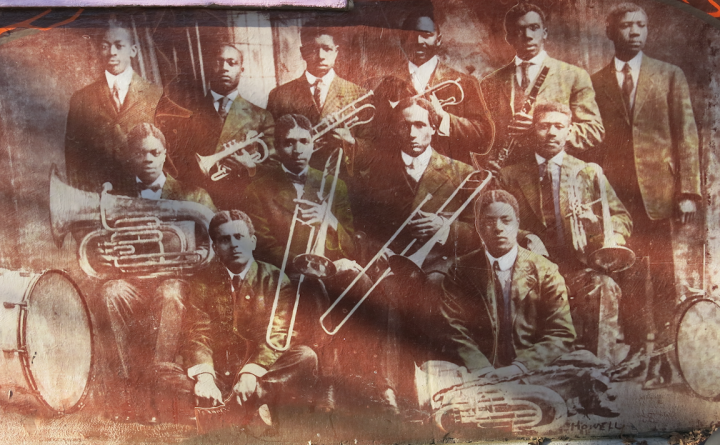 THE BAND PLAYED ON: Part of the Triangle Park Mural, the image shows the 1900 Young Men's Institute jazz band. Mural by Asheville Design Center & Just Folk Organization. Photo by Thomas Calder
