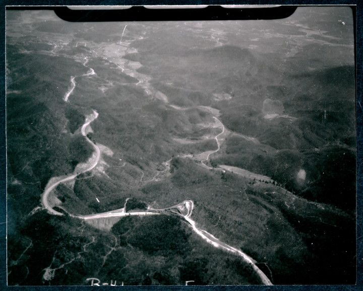 OVER THE MOUNTAIN AND THROUGH THE WOODS: An aerial view of of the construction of I-40 through the Swannanoa Gap between Ridgecrest and Old Fort. The original Route 70 can be seen below in the valley. Photo via North Carolina Collection, Pack Memorial Library, Asheville, NC