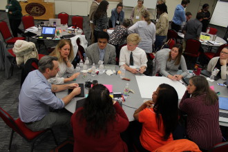 TEAM EFFORT: At the ICSEquity planning conference March 1-3, educators, administrators, community members, parents and students huddled to characterize the experiences of Asheville City Schools pupils, and how those experiences contribute to the disparities in achievement between different racial groups. Shown here is a table of representatives from Asheville High School. Photo by Virginia Daffron
