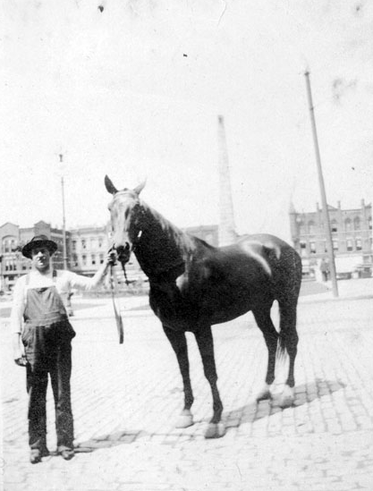 HORSING AROUND: A man and his horse stand before the Vance Monument, circa 1910.  Photo courtesy of North Carolina Collection, Pack Memorial Public Library, Asheville, North Carolina